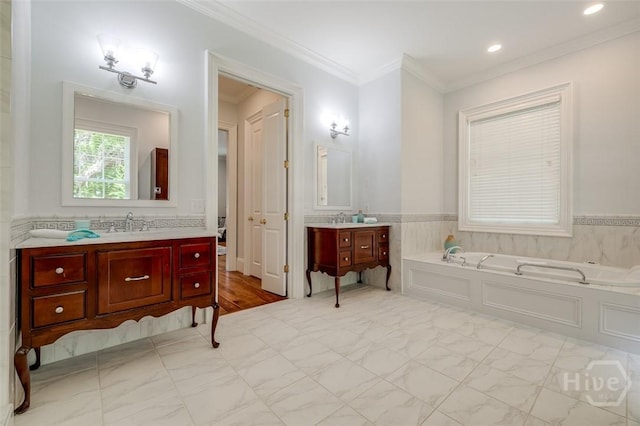 36 Belted Kingfisher Ln, Richmond Hill, GA 31324 - full bathroom featuring a bath, two vanities, ornamental molding, recessed lighting, and a wainscoted wall