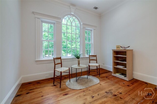 36 Belted Kingfisher Ln, Richmond Hill, GA 31324 - sitting room with wood finished floors, baseboards, and ornamental molding