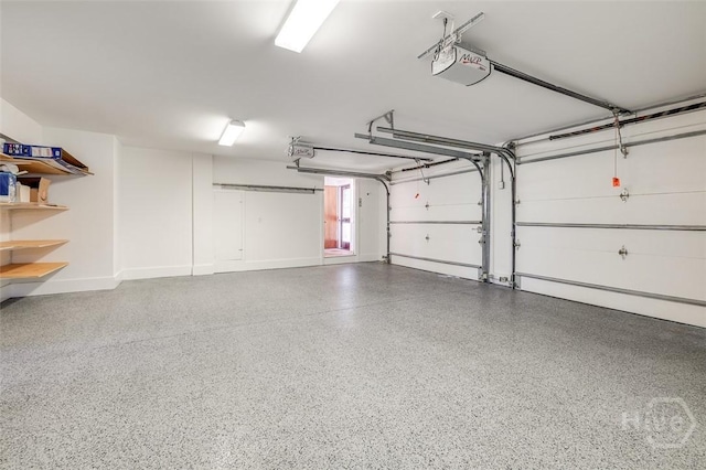 36 Belted Kingfisher Ln, Richmond Hill, GA 31324 - garage with a garage door opener and baseboards