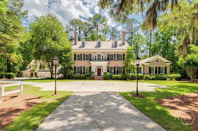36 Belted Kingfisher Ln, Richmond Hill, GA 31324 - colonial home featuring a chimney, a front yard, and brick siding