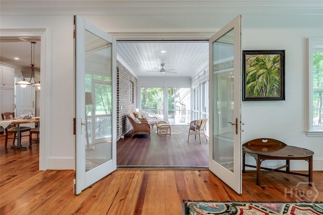 36 Belted Kingfisher Ln, Richmond Hill, GA 31324 - doorway featuring french doors, light wood finished floors, crown molding, and a ceiling fan