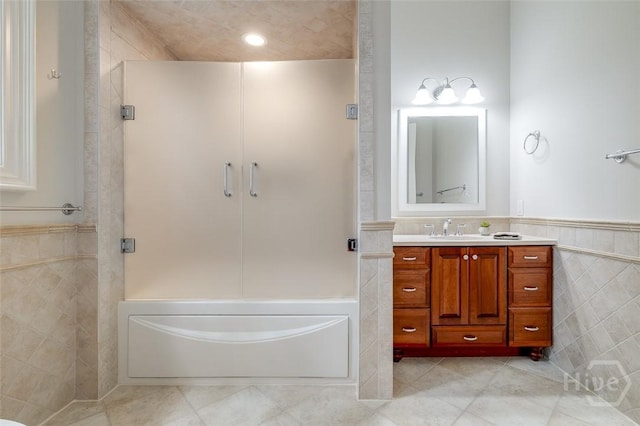 36 Belted Kingfisher Ln, Richmond Hill, GA 31324 - full bathroom featuring tile walls, tile patterned flooring, a stall shower, vanity, and wainscoting