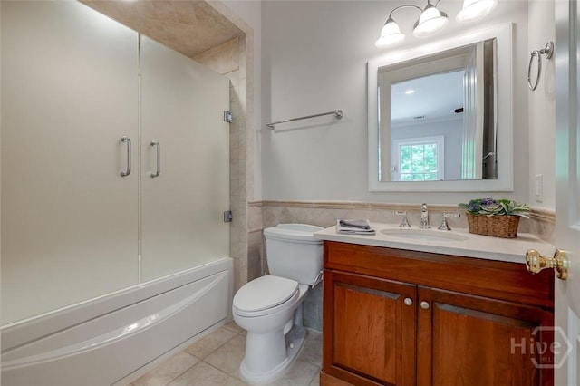 36 Belted Kingfisher Ln, Richmond Hill, GA 31324 - full bathroom featuring tile patterned floors, vanity, toilet, bath / shower combo with glass door, and wainscoting