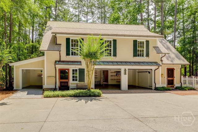 36 Belted Kingfisher Ln, Richmond Hill, GA 31324 - view of front of house featuring driveway and a standing seam roof