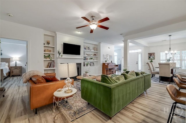 2 Iron Gate Ct, Pooler, GA 31322 - living area with light wood-style floors, a ceiling fan, a fireplace, and built in shelves