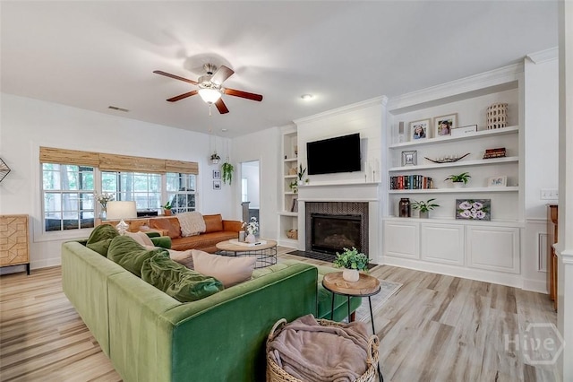 2 Iron Gate Ct, Pooler, GA 31322 - living area featuring a fireplace with flush hearth, a ceiling fan, light wood-type flooring, and built in shelves