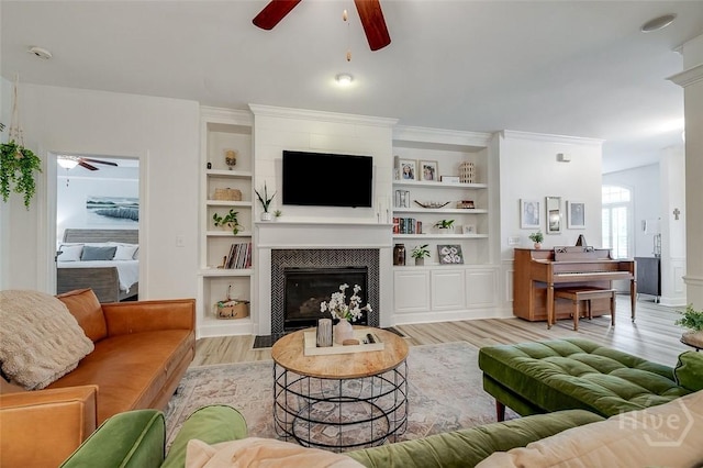 2 Iron Gate Ct, Pooler, GA 31322 - living area featuring a ceiling fan, a tile fireplace, light wood finished floors, and built in shelves