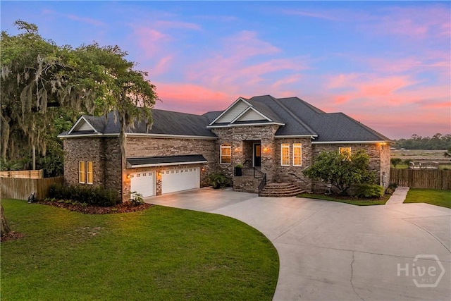907 Cheryl St, Savannah, GA 31410 - view of front of home featuring driveway, stone siding, and a garage