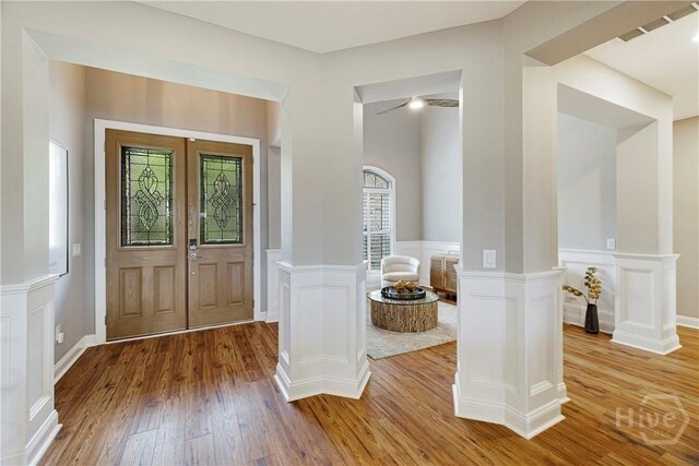 907 Cheryl St, Savannah, GA 31410 - entrance foyer with wood finished floors, a decorative wall, a wainscoted wall, and french doors