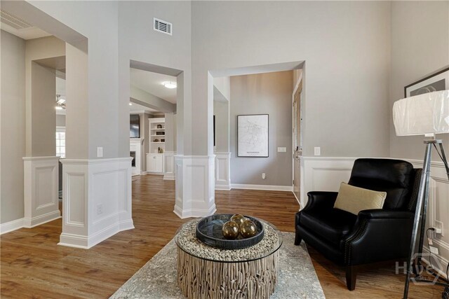 907 Cheryl St, Savannah, GA 31410 - living area with wood finished floors, a high ceiling, and ornate columns