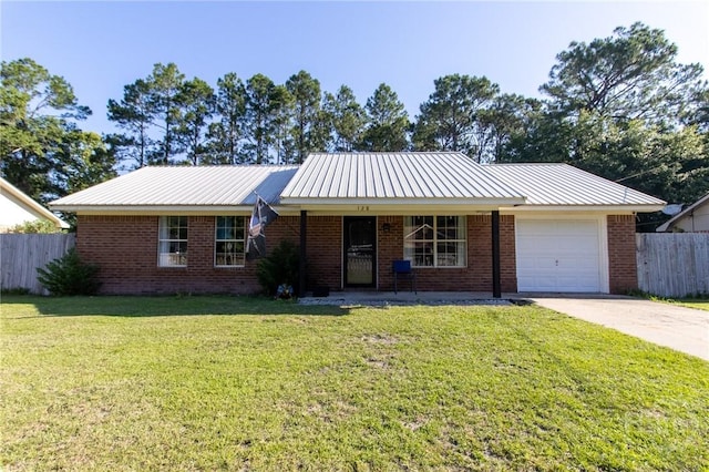 128 Deann Dr, Hinesville, GA 31313 - ranch-style house with an attached garage, driveway, brick siding, covered porch, and metal roof