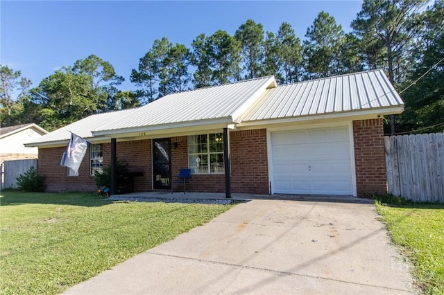 128 Deann Dr, Hinesville, GA 31313 - ranch-style home featuring an attached garage, driveway, brick siding, and metal roof