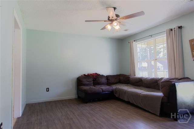 128 Deann Dr, Hinesville, GA 31313 - living area featuring wood finished floors, ceiling fan, baseboards, and a textured ceiling