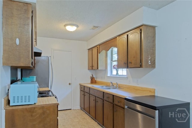 128 Deann Dr, Hinesville, GA 31313 - kitchen featuring white microwave, a sink, a textured ceiling, and light floors