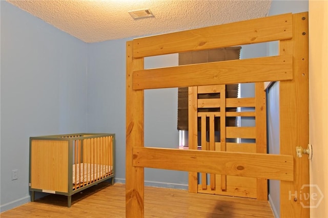 128 Deann Dr, Hinesville, GA 31313 - stairway featuring wood finished floors, a relaxing sauna, a textured ceiling, and baseboards