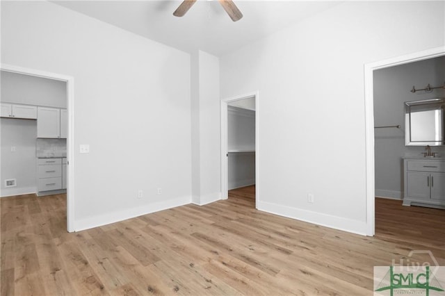 826 W Victory Dr, Savannah, GA 31405 - unfurnished bedroom featuring a walk in closet, a closet, and light wood-style floors