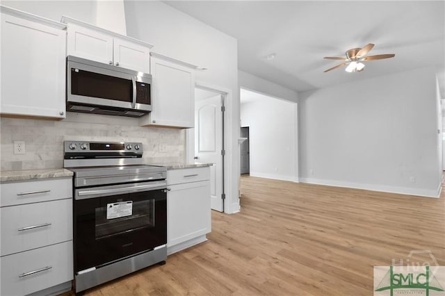 826 W Victory Dr, Savannah, GA 31405 - kitchen with stainless steel appliances, a ceiling fan, white cabinets, backsplash, and light wood-style flooring