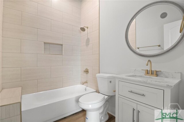 826 W Victory Dr, Savannah, GA 31405 - bathroom with toilet, wood finished floors, vanity, and shower / bathtub combination