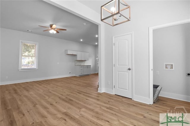 826 W Victory Dr, Savannah, GA 31405 - unfurnished living room featuring light wood-type flooring, a chandelier, baseboards, ceiling fan, and recessed lighting