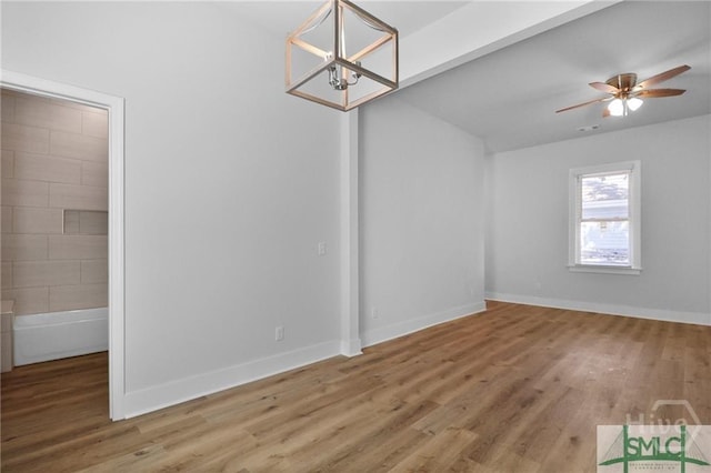 826 W Victory Dr, Savannah, GA 31405 - unfurnished dining area with wood finished floors, a chandelier, a ceiling fan, and baseboards