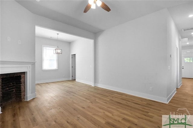 826 W Victory Dr, Savannah, GA 31405 - unfurnished living room with a ceiling fan, wood finished floors, plenty of natural light, and baseboards