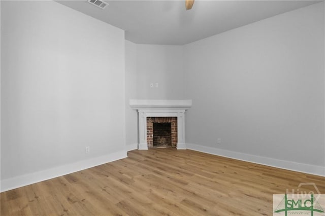 826 W Victory Dr, Savannah, GA 31405 - unfurnished living room featuring a fireplace, wood finished floors, and baseboards
