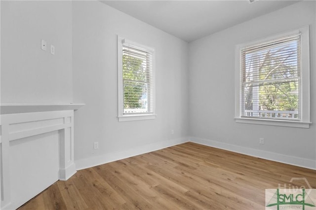 826 W Victory Dr, Savannah, GA 31405 - unfurnished living room with light wood-style flooring and baseboards