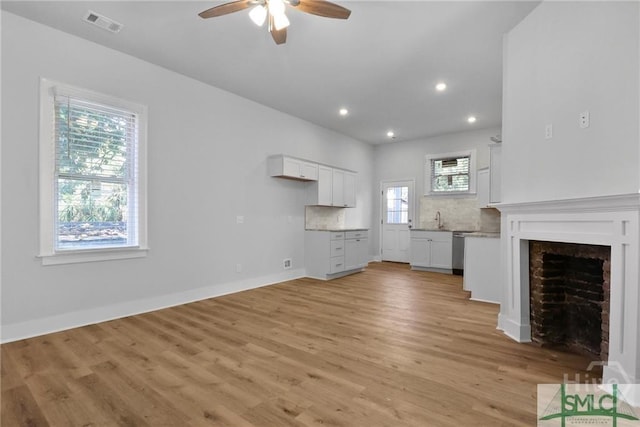 826 W Victory Dr, Savannah, GA 31405 - unfurnished living room featuring ceiling fan, light wood-style floors, recessed lighting, a fireplace, and baseboards