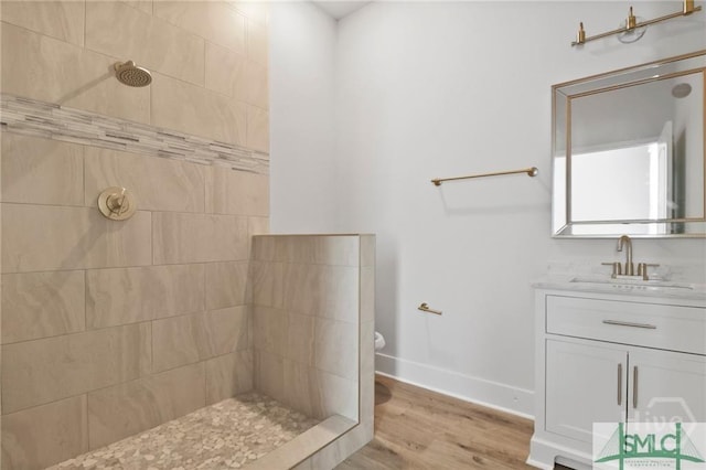 826 W Victory Dr, Savannah, GA 31405 - full bathroom featuring tiled shower, vanity, wood finished floors, toilet, and baseboards