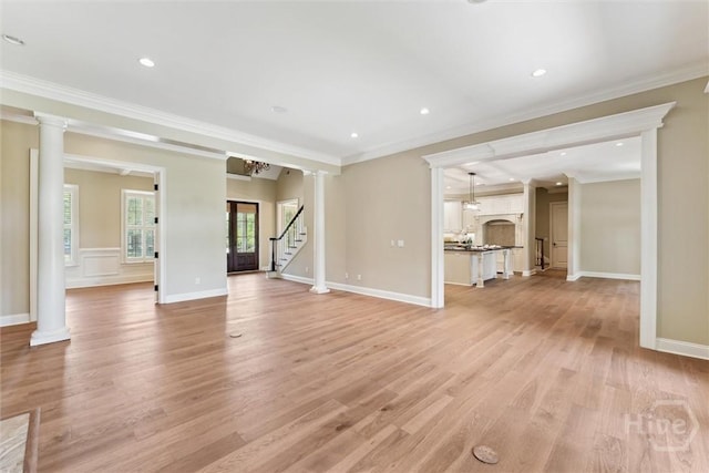 104 Post House Trl, Pooler, GA 31322 - unfurnished living room with crown molding, light wood-style flooring, ornate columns, stairs, and baseboards