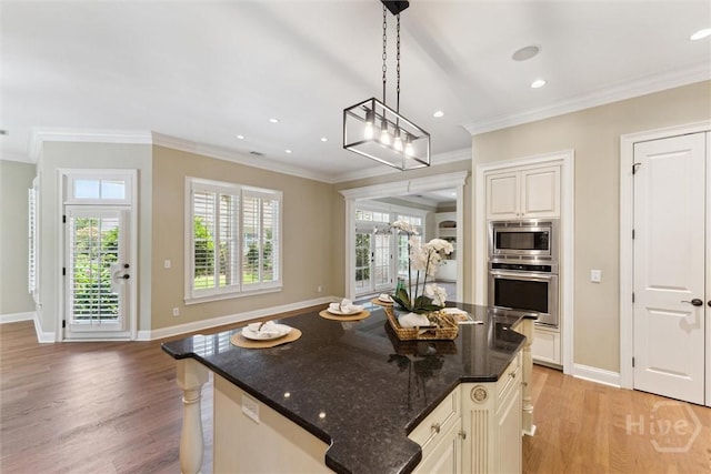 104 Post House Trl, Pooler, GA 31322 - kitchen with appliances with stainless steel finishes, light wood-style flooring, baseboards, dark stone counters, and crown molding
