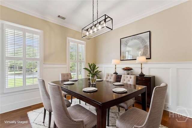 104 Post House Trl, Pooler, GA 31322 - dining space with wainscoting, wood finished floors, ornamental molding, a decorative wall, and a chandelier