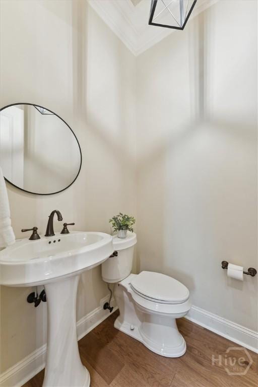 104 Post House Trl, Pooler, GA 31322 - half bathroom featuring toilet, wood finished floors, ornamental molding, baseboards, and a sink