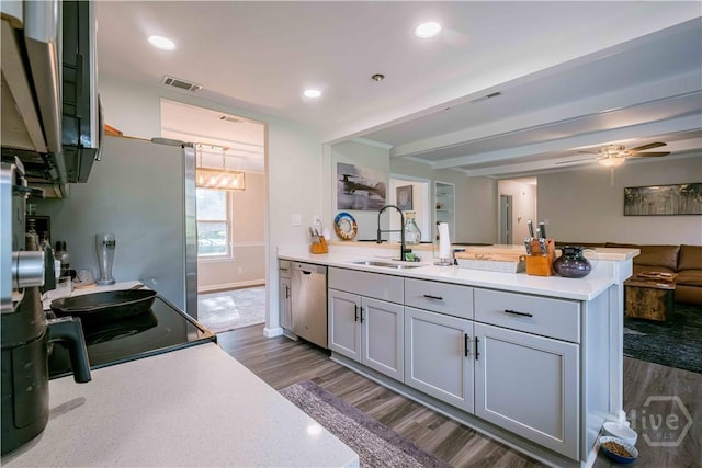 3 Black Forest Dr, Savannah, GA 31410 - kitchen with a sink, appliances with stainless steel finishes, a peninsula, dark wood-style flooring, and beamed ceiling