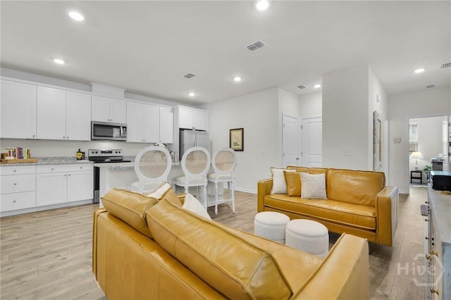142 Benelli Dr, Pooler, GA 31322 - living area featuring light wood-type flooring, recessed lighting, and baseboards