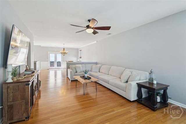 43 Godley Park Way, Savannah, GA 31407 - living room featuring a chandelier, a ceiling fan, and light wood-type flooring