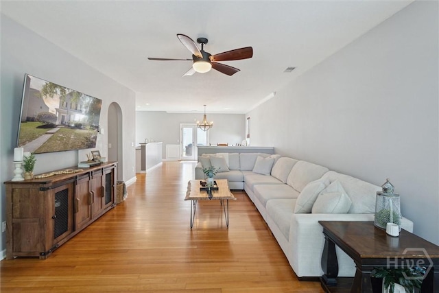 43 Godley Park Way, Savannah, GA 31407 - living room with light wood-style floors, arched walkways, a ceiling fan, and a chandelier