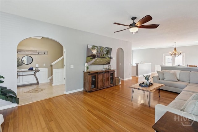 43 Godley Park Way, Savannah, GA 31407 - living area with arched walkways, stairway, light wood-type flooring, ceiling fan, and a chandelier