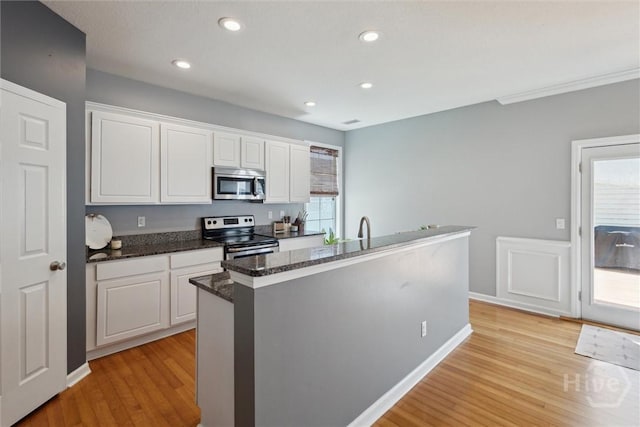 43 Godley Park Way, Savannah, GA 31407 - kitchen with appliances with stainless steel finishes, light wood-type flooring, white cabinets, dark stone countertops, and recessed lighting
