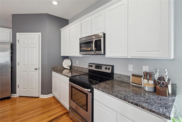 43 Godley Park Way, Savannah, GA 31407 - kitchen featuring appliances with stainless steel finishes, light wood-style floors, white cabinetry, baseboards, and dark stone counters