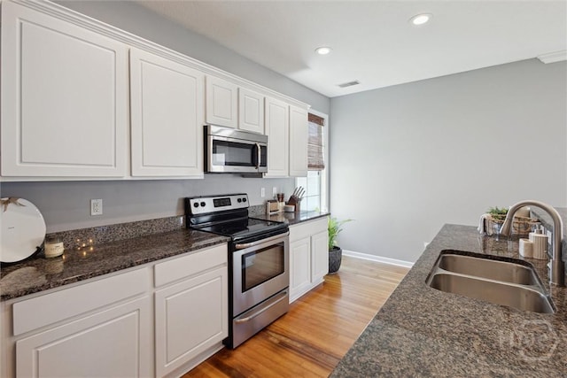43 Godley Park Way, Savannah, GA 31407 - kitchen with stainless steel appliances, a sink, light wood-style floors, white cabinetry, and recessed lighting