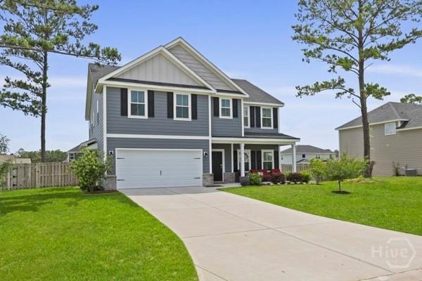150 Pitch Point Trl, Richmond Hill, GA 31324 - craftsman inspired home featuring covered porch, concrete driveway, a garage, and board and batten siding
