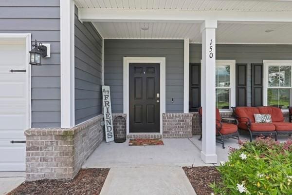 150 Pitch Point Trl, Richmond Hill, GA 31324 - doorway to property with covered porch and brick siding