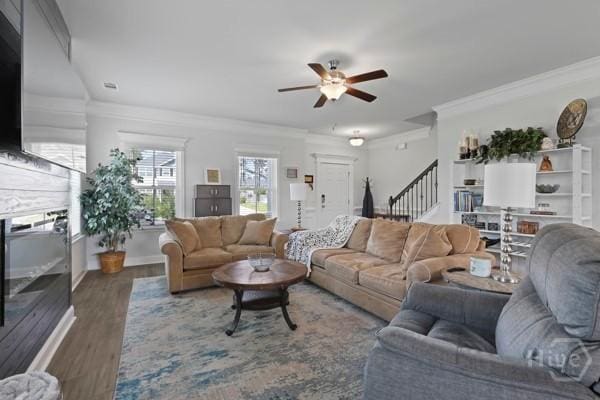 150 Pitch Point Trl, Richmond Hill, GA 31324 - living room featuring a ceiling fan, stairs, crown molding, and wood finished floors
