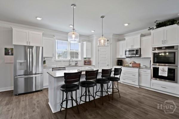 150 Pitch Point Trl, Richmond Hill, GA 31324 - kitchen with stainless steel appliances, backsplash, white cabinetry, and recessed lighting