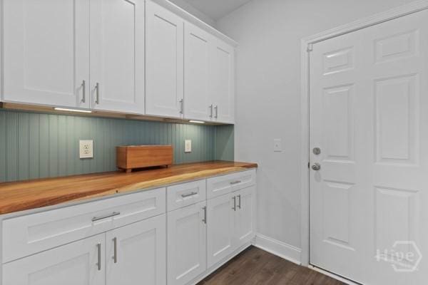 150 Pitch Point Trl, Richmond Hill, GA 31324 - kitchen featuring butcher block countertops, dark wood finished floors, baseboards, and white cabinetry
