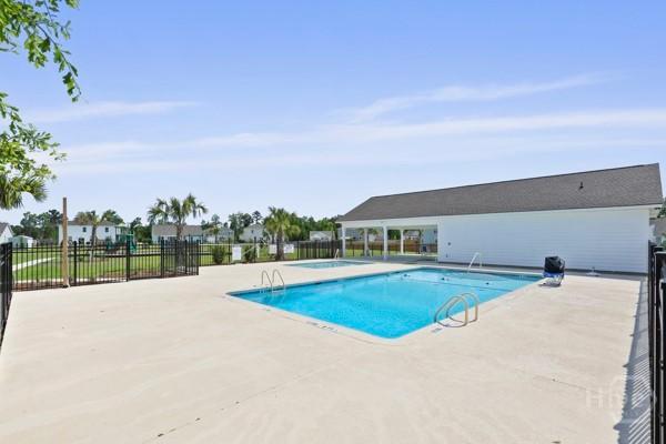 150 Pitch Point Trl, Richmond Hill, GA 31324 - community pool featuring a patio area
