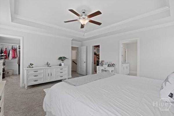 150 Pitch Point Trl, Richmond Hill, GA 31324 - bedroom featuring a raised ceiling, a walk in closet, a closet, ornamental molding, and carpet