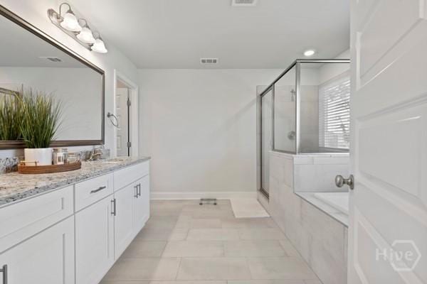 150 Pitch Point Trl, Richmond Hill, GA 31324 - full bath with a stall shower, vanity, a garden tub, baseboards, and tile patterned floors