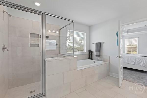 150 Pitch Point Trl, Richmond Hill, GA 31324 - ensuite bathroom with a stall shower, a garden tub, and tile patterned flooring